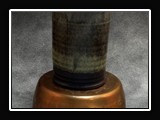 Glaze App Qa.  Q. Matte Black (O) (SG146); Stone Tan (A) (SG146) 3/4; Hazelnut (F) (SG142) 1/3. On Brown Stoneware.